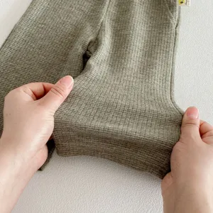 Baby waffle knit pants detail close-up showing elasticity and soft fabric quality for infants.