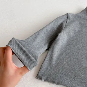 Girls grey ribbed knit top detail view, soft comfortable long sleeve shirt for spring style.