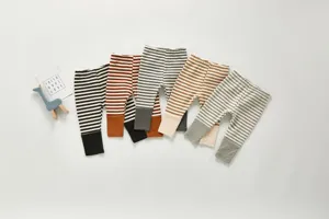 Detail view of infant striped cotton long pants with contrast ribbed cuffs, cute baby wear.