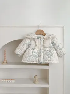 Kids winter thick warm quilted outerwear with lovely ruffles and blue floral print details.