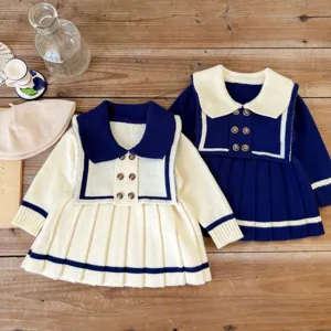 Detailed view of toddler sailor style knit pleated dress set, featuring contrasting color collars.