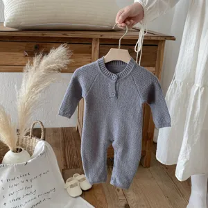 Detailed shot of baby knitted romper raglan sleeve grey autumn baby apparel close up display