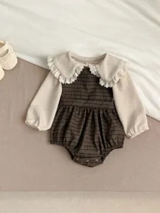 Detailed shot of baby girl plaid romper with lace collar, cute Korean style infant clothing.