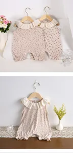 Close-up detail of infant baby girl sleeveless floral romper with cute frilly lace collar.