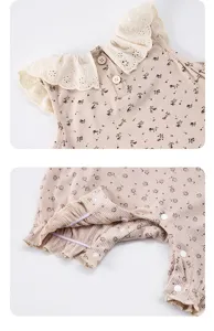 Infant baby girl floral romper detail view showcasing lace ruffle collar and snaps.