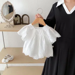 Detailed view of white baby girl flying sleeve cotton lace romper, delicate floral lace edging.