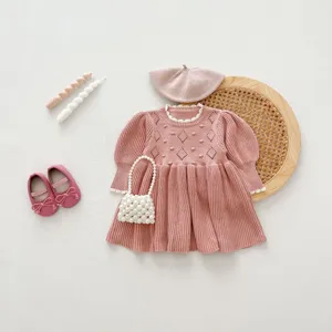 Cute baby girl knit dress detail flat lay, cozy long sleeve princess sweater outfit accessories.