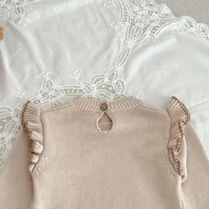 Süßer Babymädchen Strickpullover mit Rüschenschultern und Knopfverschluss am Rücken.