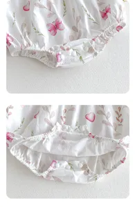 Baby romper detail shot featuring cute butterfly and leaf print patterns with bottom snaps.