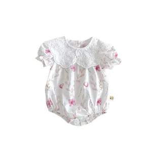 Cute infant baby girl romper with delicate lace collar and floral print summer wear.