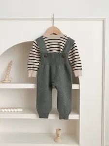 Cute baby knit sweater and overall pants set, cozy infant autumn clothing with striped top.
