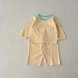 Adorable baby cotton checkered pajama set featuring a cozy long sleeve top and pants.