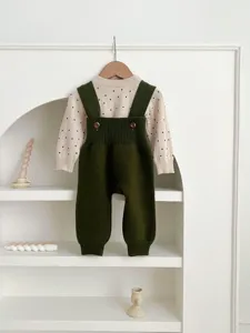 Baby knit overalls set detail, beige polka dot sweater and dark green knit pants for infant autumn.