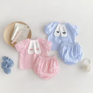 Detailed shot of baby girl striped short-sleeve top and shorts set with cute bunny ears.