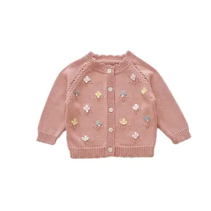 Cute baby girl pink knit cardigan sweater with handmade floral embroidery and buttons.