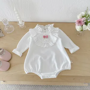 Infant baby girl long sleeve white romper with cute lace collar and pink bow detail.