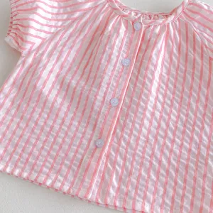 Detailed close-up view of infant baby girl pink striped short sleeve button-up summer shirt top.