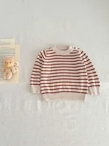 Infant striped knitted sweater detail, casual round neck with shoulder buttons, cozy fabric.