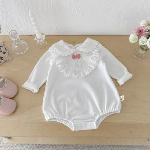 Baby white long sleeve romper detail, delicate lace doll collar with cute pink bow accent.