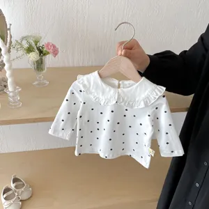 Infant baby white polka dot long sleeve blouse detail, ruffles peter pan collar display.