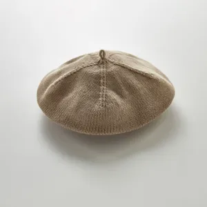 Infant knit beret detail shot showing fine textured pattern solid color baby painter hat