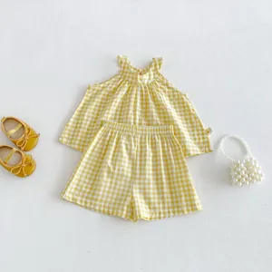 Grazioso set top halter e pantaloncini a quadretti gialli per bambini con scarpe e borsa.