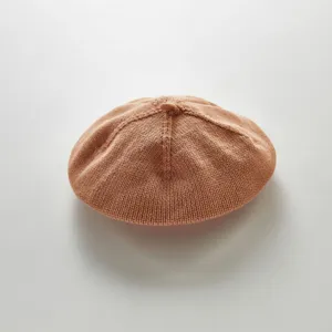 Detailed close-up of breathable knit baby beret texture, soft fabric, elegant solid color style.