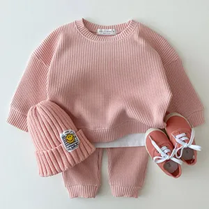 Infant waffle knit casual set, pink long sleeve top and pants for spring toddler wear detail.