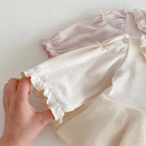 Cute baby girls long sleeve doll shirt featuring lace collar and delicate bow details.