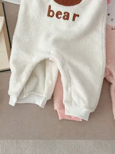 Cute fleece baby romper detail showing soft plush fabric, cozy bear embroidery and warm winter design.