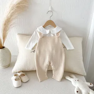 Detailed view of cute baby knit romper set with white collar top and beige overalls for infant.