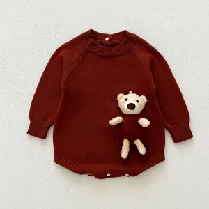 Infant knitted baby romper detail, long sleeve dark brown onesie with cute plush bear pocket.