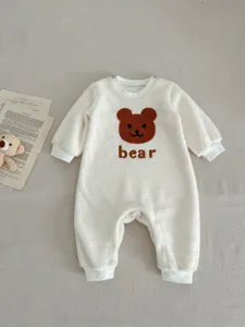 Cute fleece baby romper detail, cozy bear patch and text, warm winter wear for infants.
