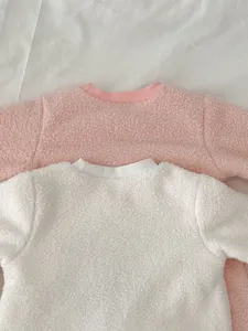 Cozy fluffy infant winter top detail, soft fleece texture, comfortable round ribbed collar.