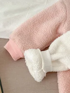 Infant baby winter warm fleece jumpsuit detail, soft cozy fuzzy sherpa material, pink and white.