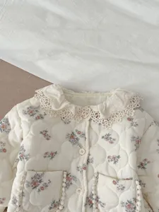 Charming baby floral quilted jacket detail with sweet lace collar and pockets for winter.