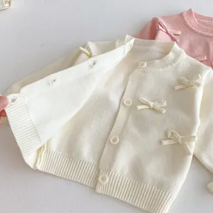 Baby girls knit cardigan sweater with cute bow decorations, soft fabric, sweet autumn toddler top.