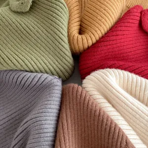 Close-up detail of colorful ribbed knit baby clothing texture, multi-color woolen fabric.