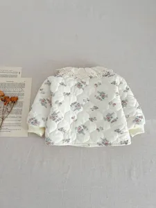 Floral quilted infant jacket detail showcasing exquisite lace collar and cozy padded texture.