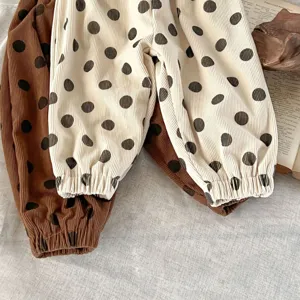 Primo piano dettagliato di pantaloni invernali in velluto a coste con pois, tessuto morbido.