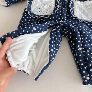 Baby winter fleece jumpsuit detail shot, navy blue polka dot baby romper with lace pockets.