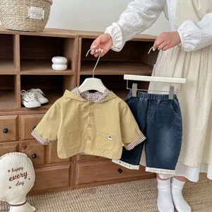 Toddler clothing set detail view featuring khaki hooded jacket and stylish denim pants.