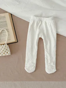Infant toddler white fleece-lined footed tights, cozy textured fabric with cute floral detail.