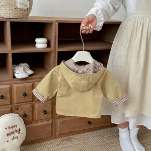 Baby hooded trench coat detail showing brown checkered lining and cute khaki sleeve cuffs.