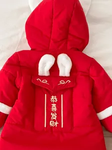 Infant red winter jumpsuit detail, rabbit ears hood, festive New Year baby romper back view.
