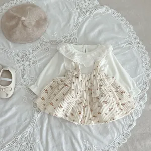 Baby girl floral corduroy suspender skirt detail with lace blouse and cute styling.