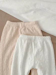 Detailed view of infant toddler textured crinkle pull-up pants in soft pastel shades.