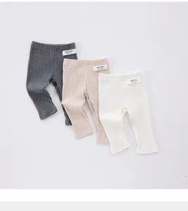 Detailed view of soft ribbed baby leggings in three solid colors, comfortable and elastic.