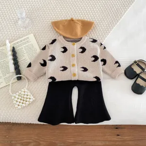 Infant knit cardigan set with moon print, beige sweater and black flare pants for baby.