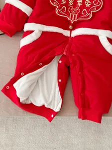 Red baby winter jumpsuit detail, thick warm romper for newborns with cute plush trim and snaps.